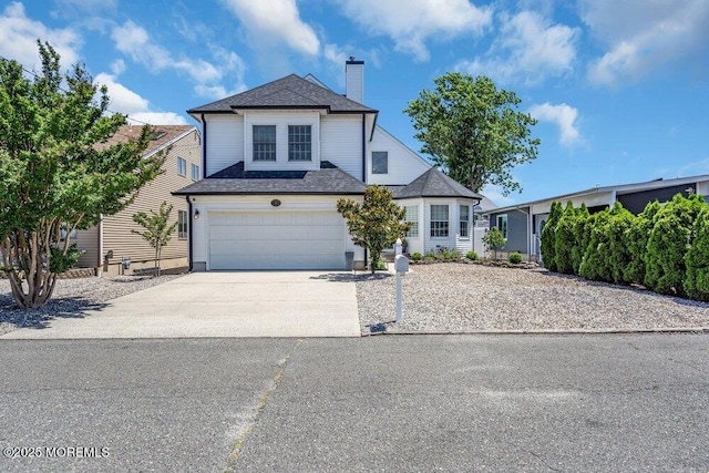 17 W Coral Dr, Brick, NJ 08723 - traditional-style house with concrete driveway, a chimney, roof with shingles, and an attached garage