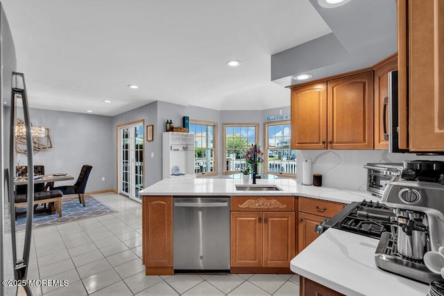17 W Coral Dr, Brick, NJ 08723 - kitchen featuring stainless steel dishwasher, brown cabinets, a peninsula, light stone counters, and recessed lighting
