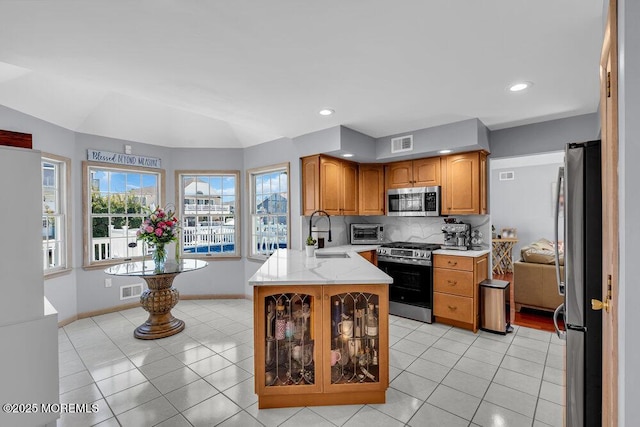 17 W Coral Dr, Brick, NJ 08723 - kitchen with stainless steel appliances, a peninsula, light tile patterned floors, tasteful backsplash, and recessed lighting