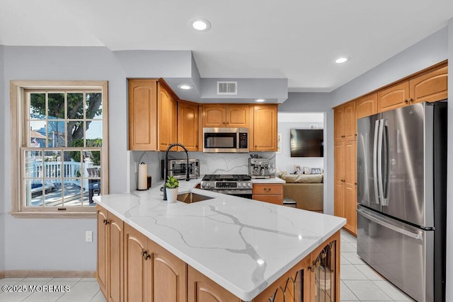 17 W Coral Dr, Brick, NJ 08723 - kitchen with appliances with stainless steel finishes, light tile patterned flooring, a peninsula, light stone counters, and recessed lighting