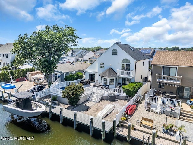 17 W Coral Dr, Brick, NJ 08723 - back of house featuring a fenced backyard, a balcony, a residential view, and a deck with water view