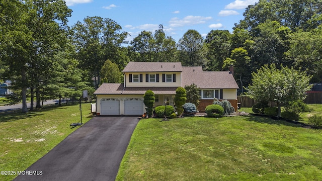 1 Spruce Way, Manalapan, NJ 07726 - view of front facade featuring driveway, an attached garage, and a chimney