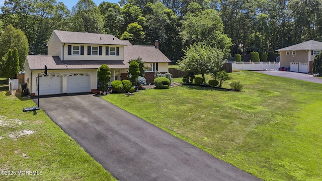 1 Spruce Way, Manalapan, NJ 07726 - view of front of house with driveway, a chimney, view of wooded area, and a shingled roof