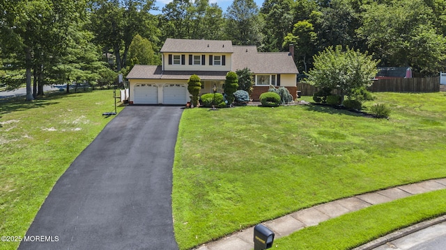 1 Spruce Way, Manalapan, NJ 07726 - view of front facade with asphalt driveway, an attached garage, and a shingled roof