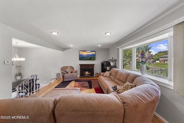 1 Spruce Way, Manalapan, NJ 07726 - living room featuring a lit fireplace, wood finished floors, a chandelier, and recessed lighting