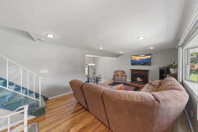 1 Spruce Way, Manalapan, NJ 07726 - living room featuring light wood finished floors, a lit fireplace, stairs, a chandelier, and recessed lighting