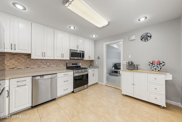 1 Spruce Way, Manalapan, NJ 07726 - kitchen featuring stainless steel appliances, backsplash, white cabinetry, and recessed lighting
