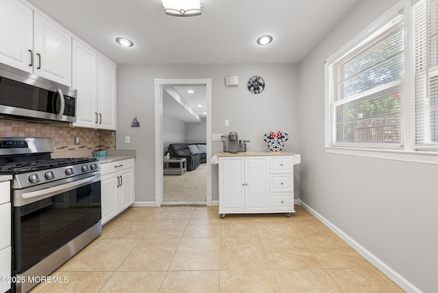 1 Spruce Way, Manalapan, NJ 07726 - kitchen with appliances with stainless steel finishes, decorative backsplash, white cabinets, light tile patterned flooring, and recessed lighting