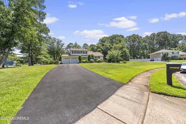 1 Spruce Way, Manalapan, NJ 07726 - view of front of property featuring a garage, a front lawn, and driveway