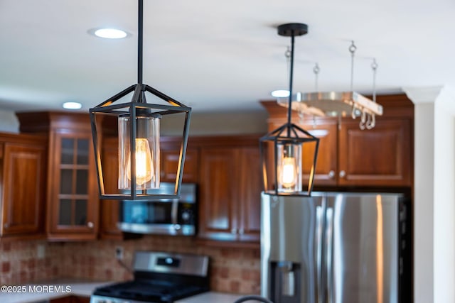 6 Frances Ct, Red Bank, NJ 07701 - kitchen featuring appliances with stainless steel finishes, brown cabinetry, pendant lighting, glass insert cabinets, and backsplash