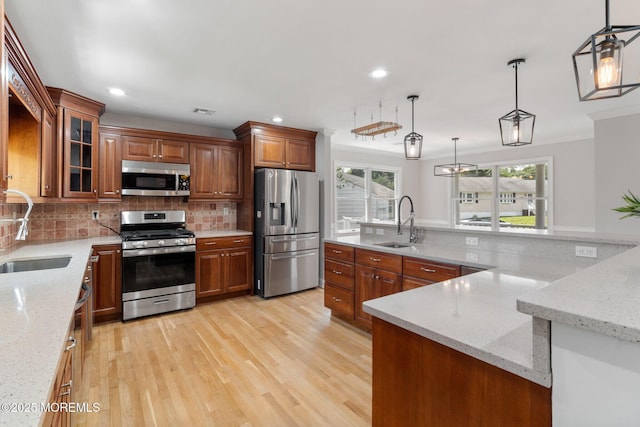 6 Frances Ct, Red Bank, NJ 07701 - kitchen featuring appliances with stainless steel finishes, light wood-style floors, decorative backsplash, brown cabinets, and recessed lighting