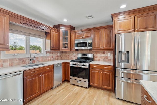 6 Frances Ct, Red Bank, NJ 07701 - kitchen with appliances with stainless steel finishes, brown cabinetry, light wood finished floors, and recessed lighting