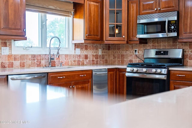 6 Frances Ct, Red Bank, NJ 07701 - kitchen featuring appliances with stainless steel finishes, light countertops, backsplash, and glass insert cabinets