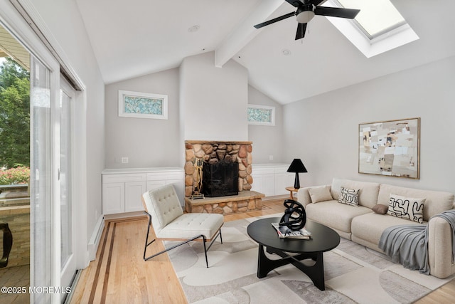 6 Frances Ct, Red Bank, NJ 07701 - living area featuring light wood-style floors, beamed ceiling, ceiling fan, a stone fireplace, and a skylight