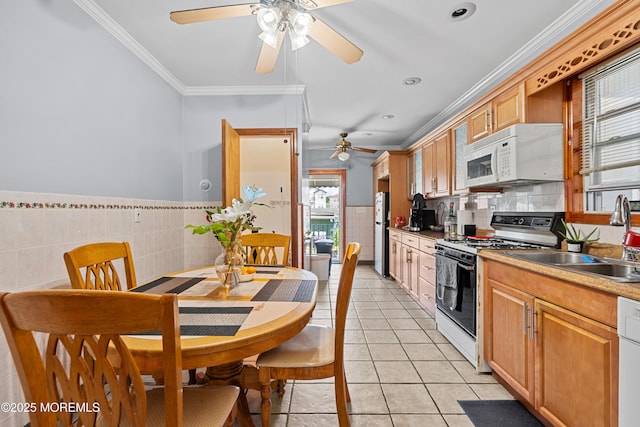 612 Grier Ave, Elizabeth, NJ 07202 - kitchen with white appliances, a ceiling fan, light tile patterned floors, crown molding, and tile walls