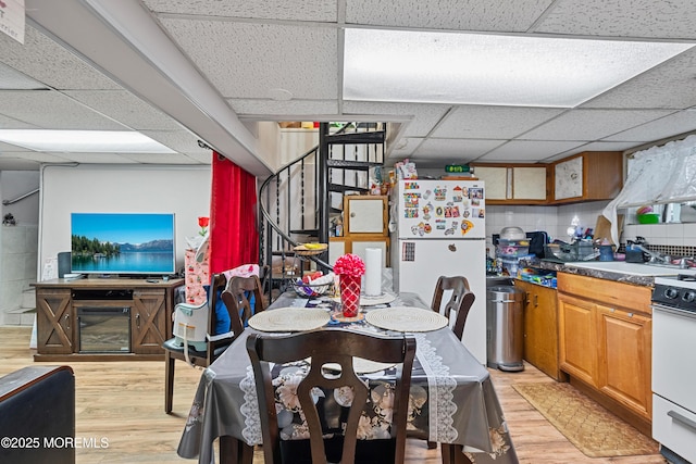 612 Grier Ave, Elizabeth, NJ 07202 - dining area with a paneled ceiling, light wood-style floors, and stairs