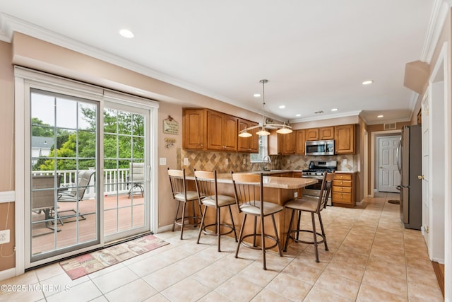 15 Bronia St, Howell, NJ 07731 - kitchen with stainless steel appliances, brown cabinets, a peninsula, ornamental molding, and light tile patterned floors