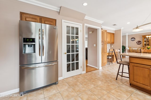 15 Bronia St, Howell, NJ 07731 - kitchen featuring stainless steel fridge with ice dispenser, crown molding, light tile patterned floors, a breakfast bar area, and recessed lighting