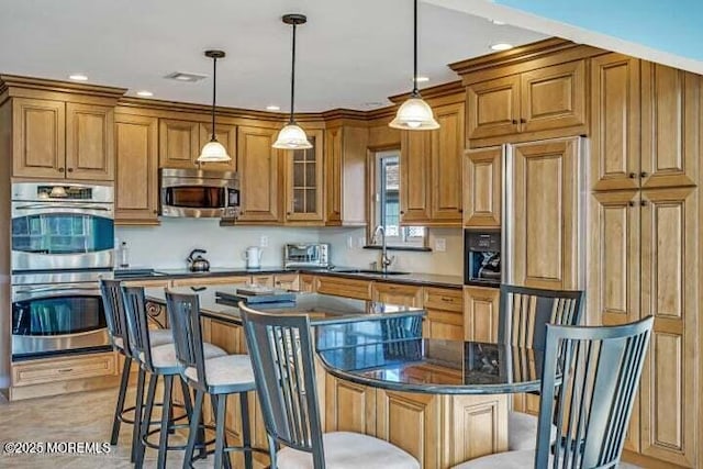 45 Leighton Ln, Manchester, NJ 08759 - kitchen with stainless steel appliances, brown cabinetry, a breakfast bar, a center island, and recessed lighting