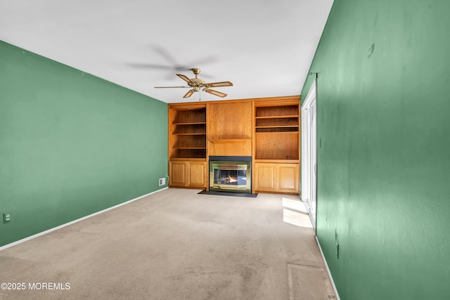 1 Denise Ct, Tinton Falls, NJ 07753 - unfurnished living room with light carpet, a fireplace with flush hearth, a ceiling fan, and built in shelves