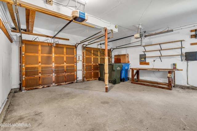 1 Denise Ct, Tinton Falls, NJ 07753 - garage featuring a garage door opener, a workshop area, and electric panel