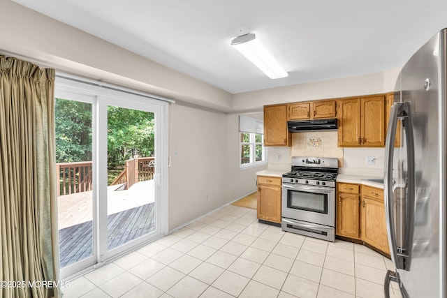 1 Denise Ct, Tinton Falls, NJ 07753 - kitchen with stainless steel appliances, under cabinet range hood, light countertops, tasteful backsplash, and brown cabinetry