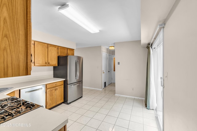 1 Denise Ct, Tinton Falls, NJ 07753 - kitchen featuring appliances with stainless steel finishes, light countertops, light tile patterned floors, and brown cabinetry