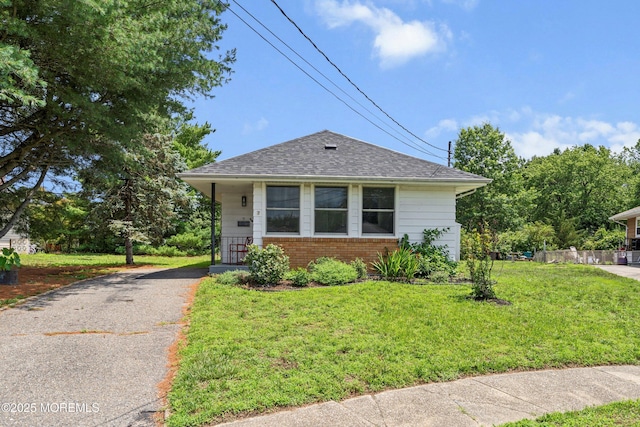 7 Bear Mountain Ct, Toms River, NJ 08753 - bungalow-style house featuring brick siding, a front yard, asphalt driveway, and roof with shingles