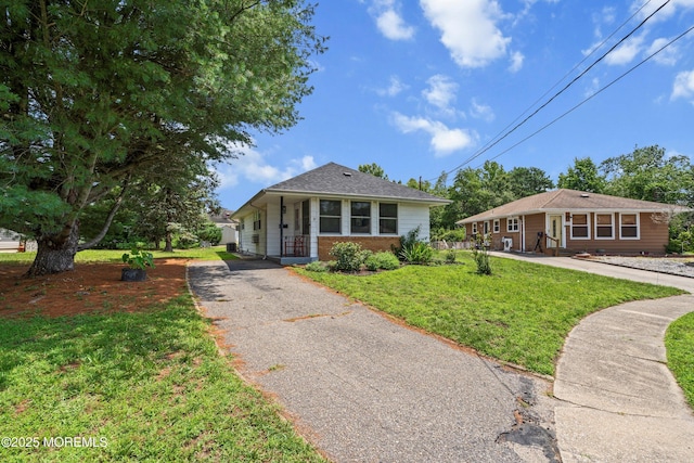 7 Bear Mountain Ct, Toms River, NJ 08753 - bungalow-style home with asphalt driveway, a front yard, and brick siding
