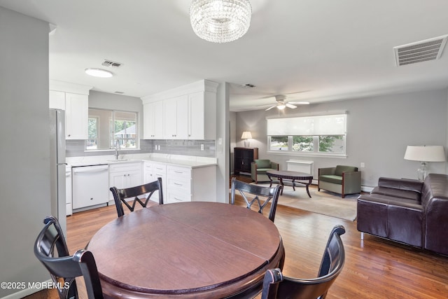 7 Bear Mountain Ct, Toms River, NJ 08753 - dining room with light wood-type flooring, a ceiling fan, a chandelier, and baseboard heating