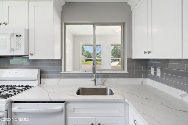 7 Bear Mountain Ct, Toms River, NJ 08753 - kitchen with white appliances, white cabinets, decorative backsplash, and light stone countertops