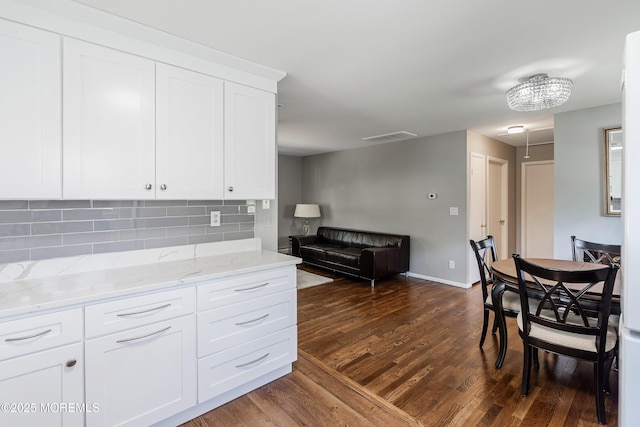 7 Bear Mountain Ct, Toms River, NJ 08753 - kitchen with dark wood finished floors, tasteful backsplash, light stone countertops, white cabinets, and open floor plan