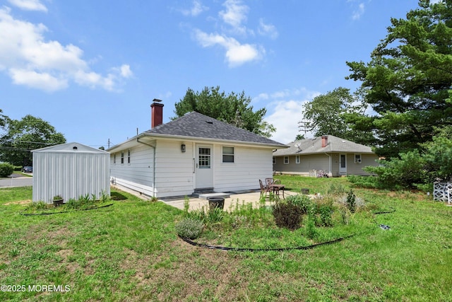7 Bear Mountain Ct, Toms River, NJ 08753 - back of house with a lawn, a chimney, an outbuilding, a patio area, and roof with shingles