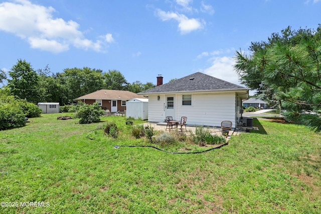 7 Bear Mountain Ct, Toms River, NJ 08753 - rear view of property with a storage shed, a patio area, a lawn, and a chimney