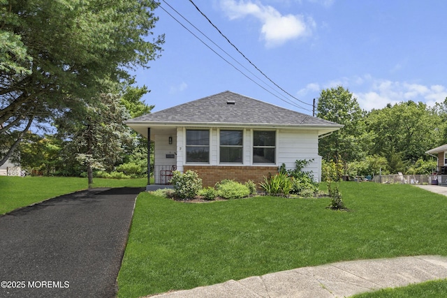 7 Bear Mountain Ct, Toms River, NJ 08753 - view of front of property with brick siding, a front yard, a shingled roof, and asphalt driveway