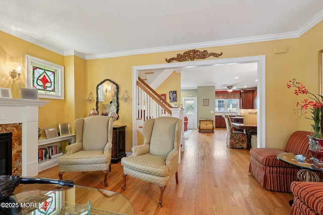 73 Clark Ave, Ocean Grove, NJ 07756 - living room featuring stairs, light wood-style floors, crown molding, ceiling fan, and a premium fireplace