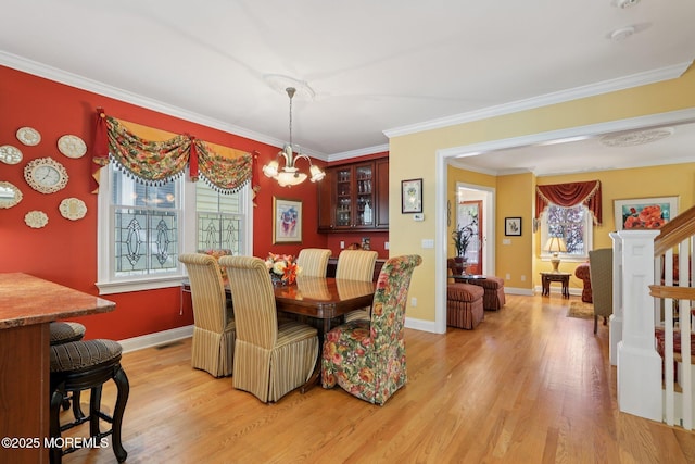 73 Clark Ave, Ocean Grove, NJ 07756 - dining room with healthy amount of natural light, light wood-style floors, crown molding, a chandelier, and stairway