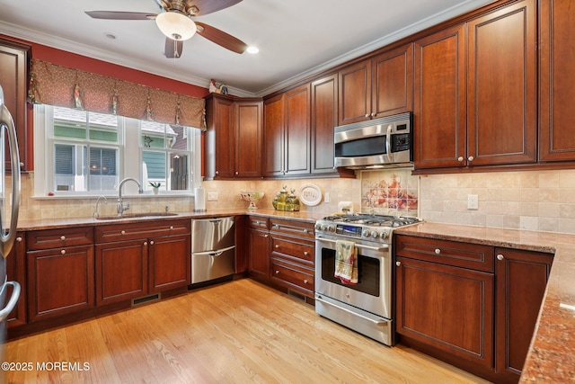73 Clark Ave, Ocean Grove, NJ 07756 - kitchen with appliances with stainless steel finishes, light stone counters, ceiling fan, ornamental molding, and light wood-type flooring