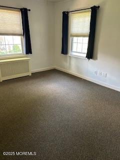 26 Pinckney Rd Unit C, Red Bank, NJ 07701 - unfurnished room with radiator heating unit and dark carpet