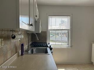 26 Pinckney Rd Unit C, Red Bank, NJ 07701 - kitchen featuring a sink and white cabinets