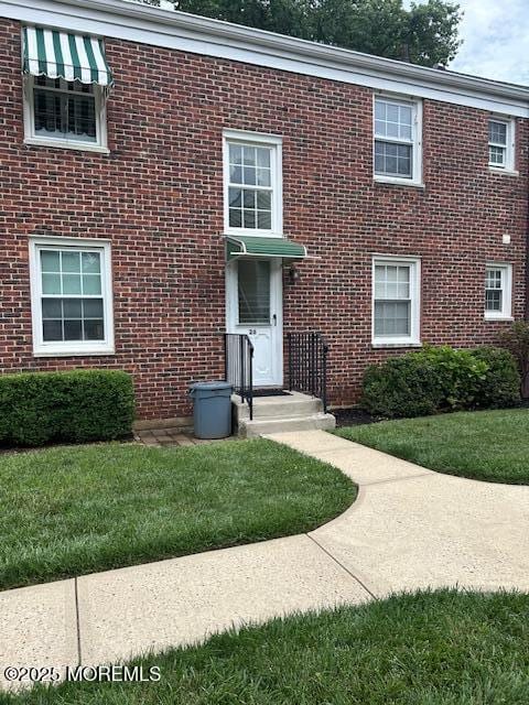 26 Pinckney Rd Unit C, Red Bank, NJ 07701 - view of front of home with brick siding and a front yard