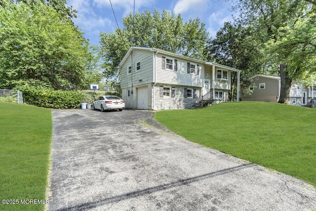 123 Susan Dr, Jackson, NJ 08527 - bi-level home with driveway, a front lawn, a garage, and stone siding