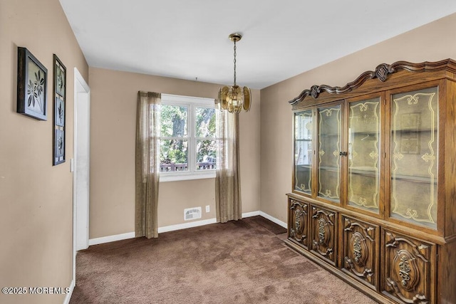 123 Susan Dr, Jackson, NJ 08527 - unfurnished dining area featuring a chandelier and dark carpet