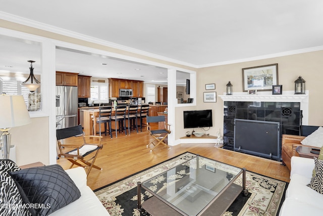 49 Farragut Dr, Brick, NJ 08723 - living room with crown molding, light wood-style flooring, and a fireplace