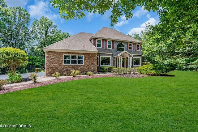 3 Algonquin Ct, Freehold, NJ 07728 - view of front facade featuring a front yard, roof with shingles, and stone siding