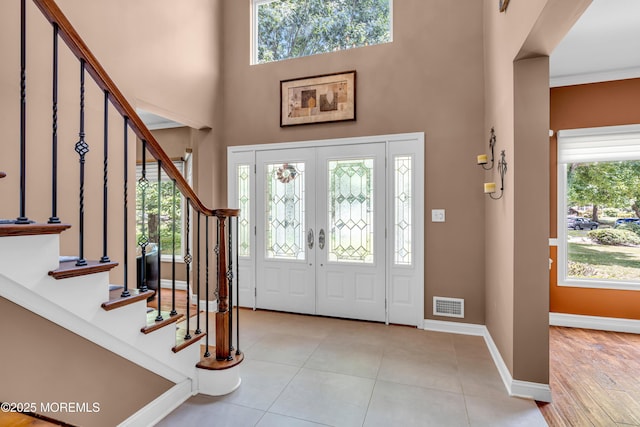 3 Algonquin Ct, Freehold, NJ 07728 - tiled foyer entrance with a high ceiling, stairs, healthy amount of natural light, and french doors