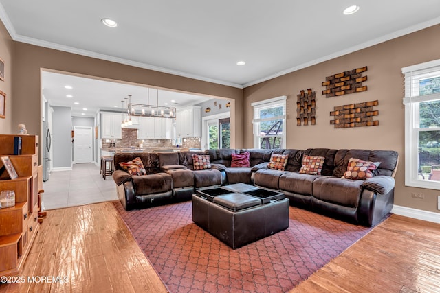 3 Algonquin Ct, Freehold, NJ 07728 - living area featuring light wood-style floors, recessed lighting, crown molding, and a chandelier