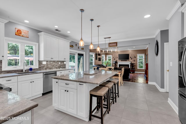 3 Algonquin Ct, Freehold, NJ 07728 - kitchen with ornamental molding, decorative backsplash, a breakfast bar, a kitchen island, and open floor plan
