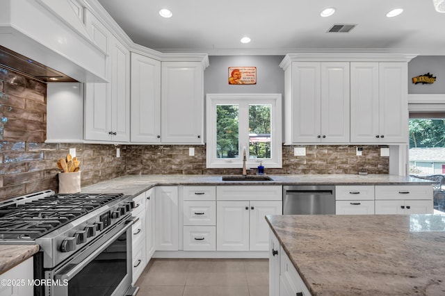 3 Algonquin Ct, Freehold, NJ 07728 - kitchen with appliances with stainless steel finishes, ventilation hood, light tile patterned floors, white cabinetry, and light stone countertops