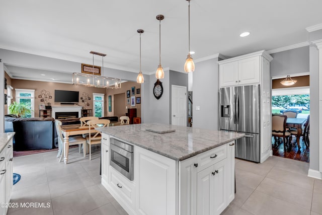 3 Algonquin Ct, Freehold, NJ 07728 - kitchen featuring appliances with stainless steel finishes, a kitchen island, open floor plan, light stone counters, and ornamental molding